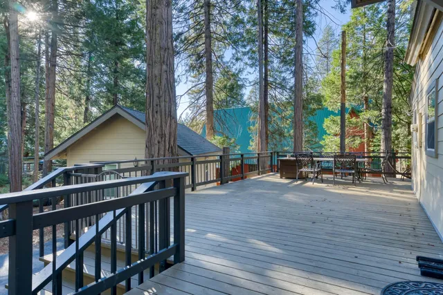 a view of a house with backyard and sitting area