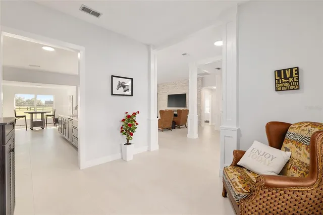 a large room with a large counter top furniture and a flat screen tv