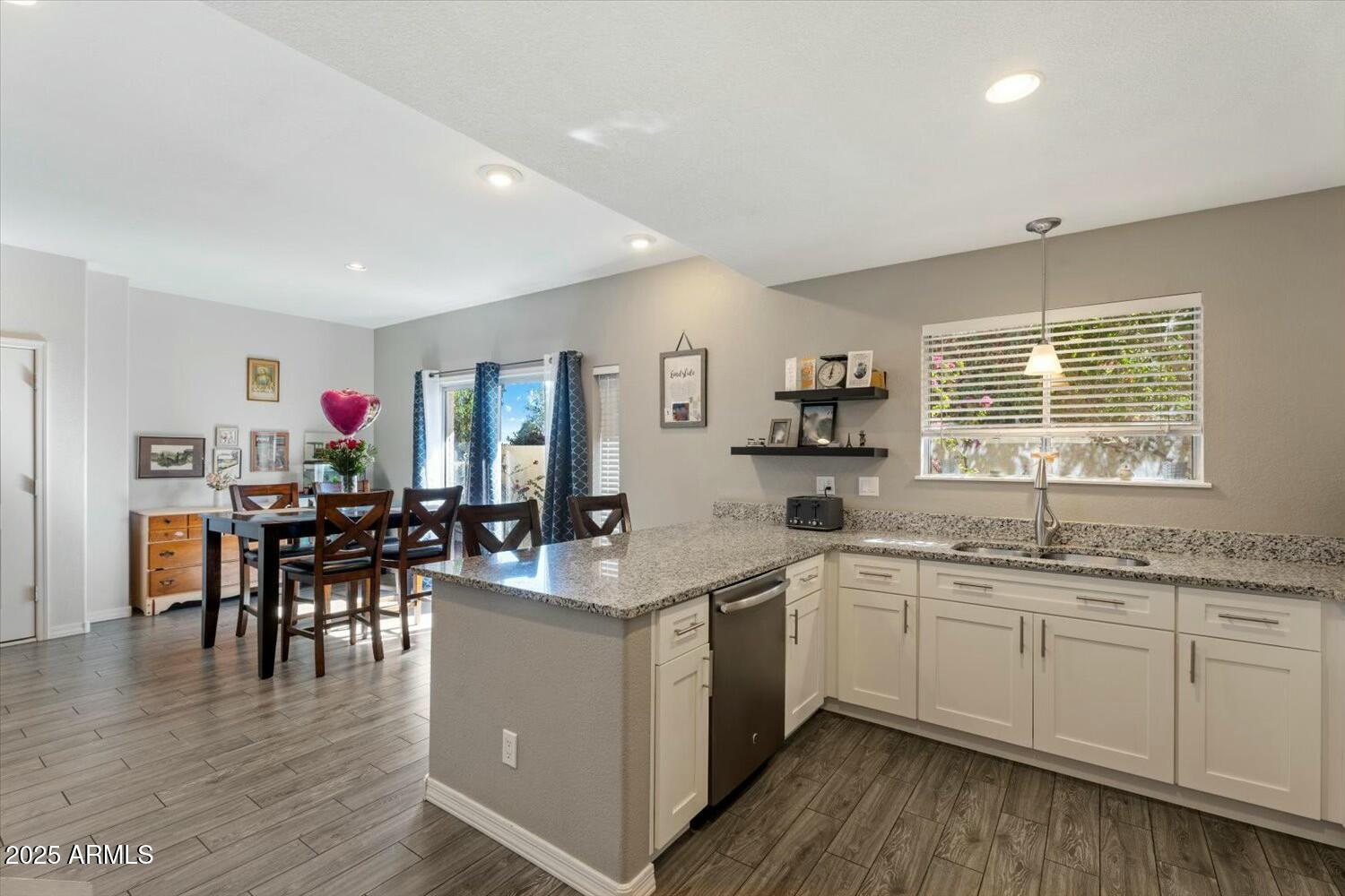8813 South 51st Street, Unit 3 Phoenix, AZ 85044 - Photo 11 of 28 a kitchen with a sink dining table cabinets and wooden floor