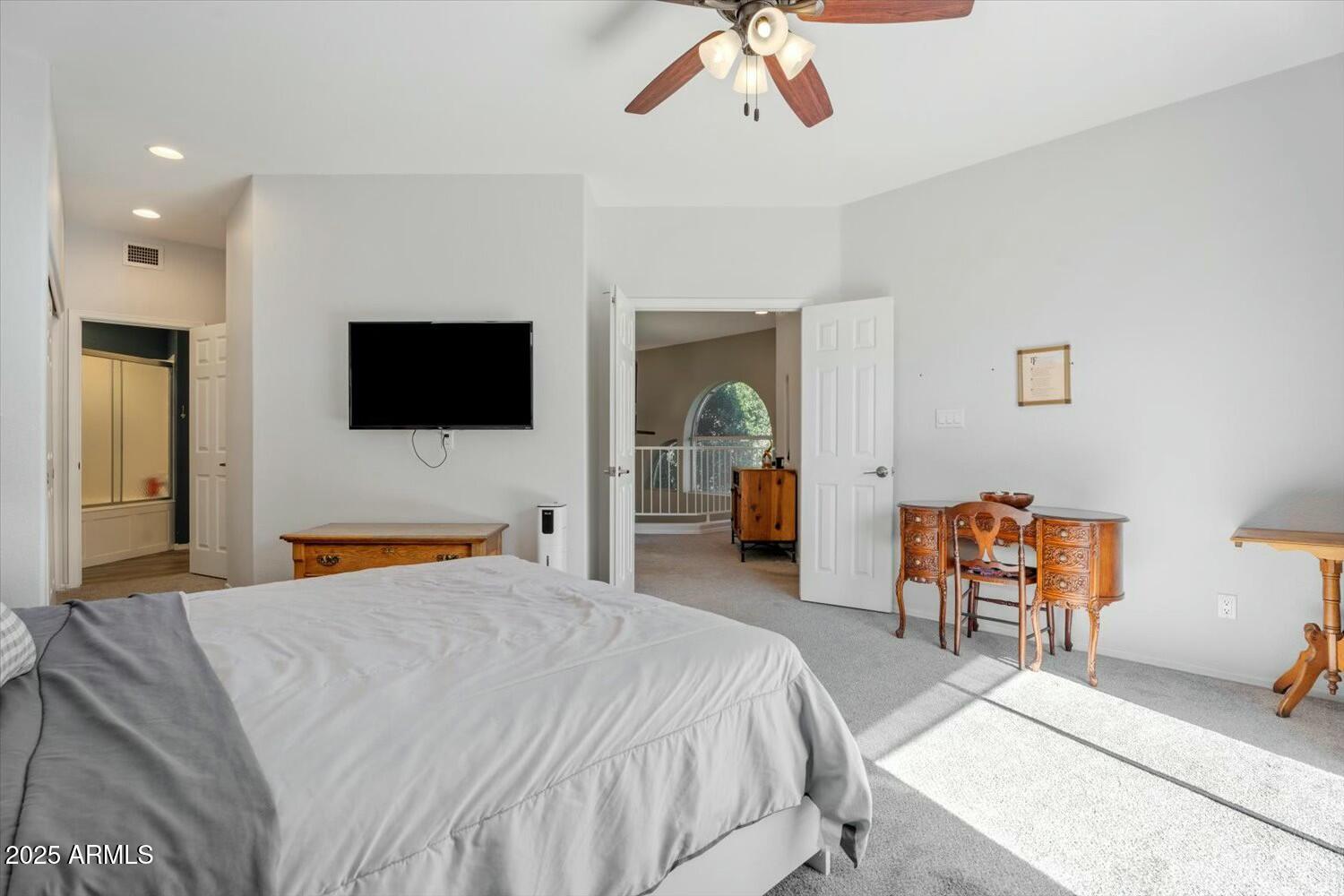 8813 South 51st Street, Unit 3 Phoenix, AZ 85044 - Photo 17 of 28 a bedroom with a bed and a flat tv screen on dresser
