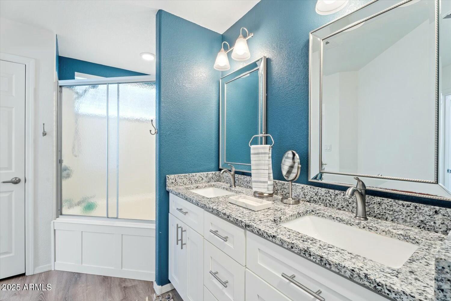8813 South 51st Street, Unit 3 Phoenix, AZ 85044 - Photo 19 of 28 a bathroom with a granite countertop double vanity sink and a mirror