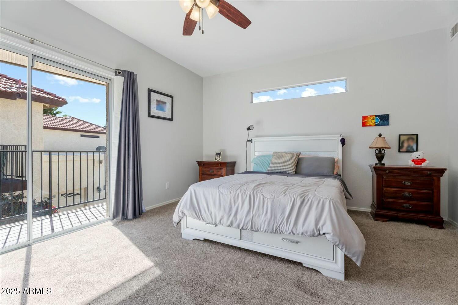 8813 South 51st Street, Unit 3 Phoenix, AZ 85044 - Photo 20 of 28 a bedroom with a bed and a chandelier