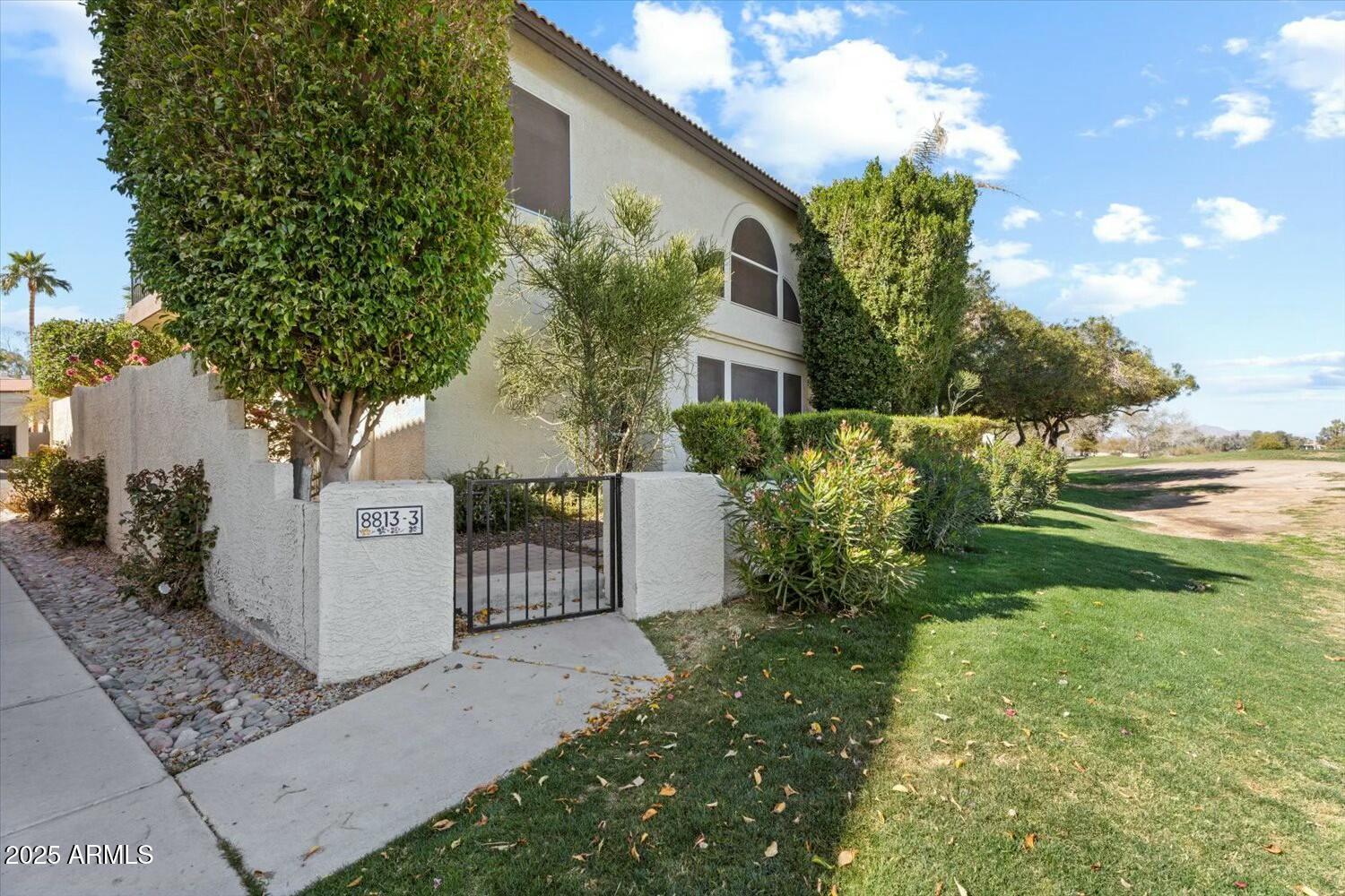 8813 South 51st Street, Unit 3 Phoenix, AZ 85044 - Photo 2 of 28 a view of a house with a yard and plants