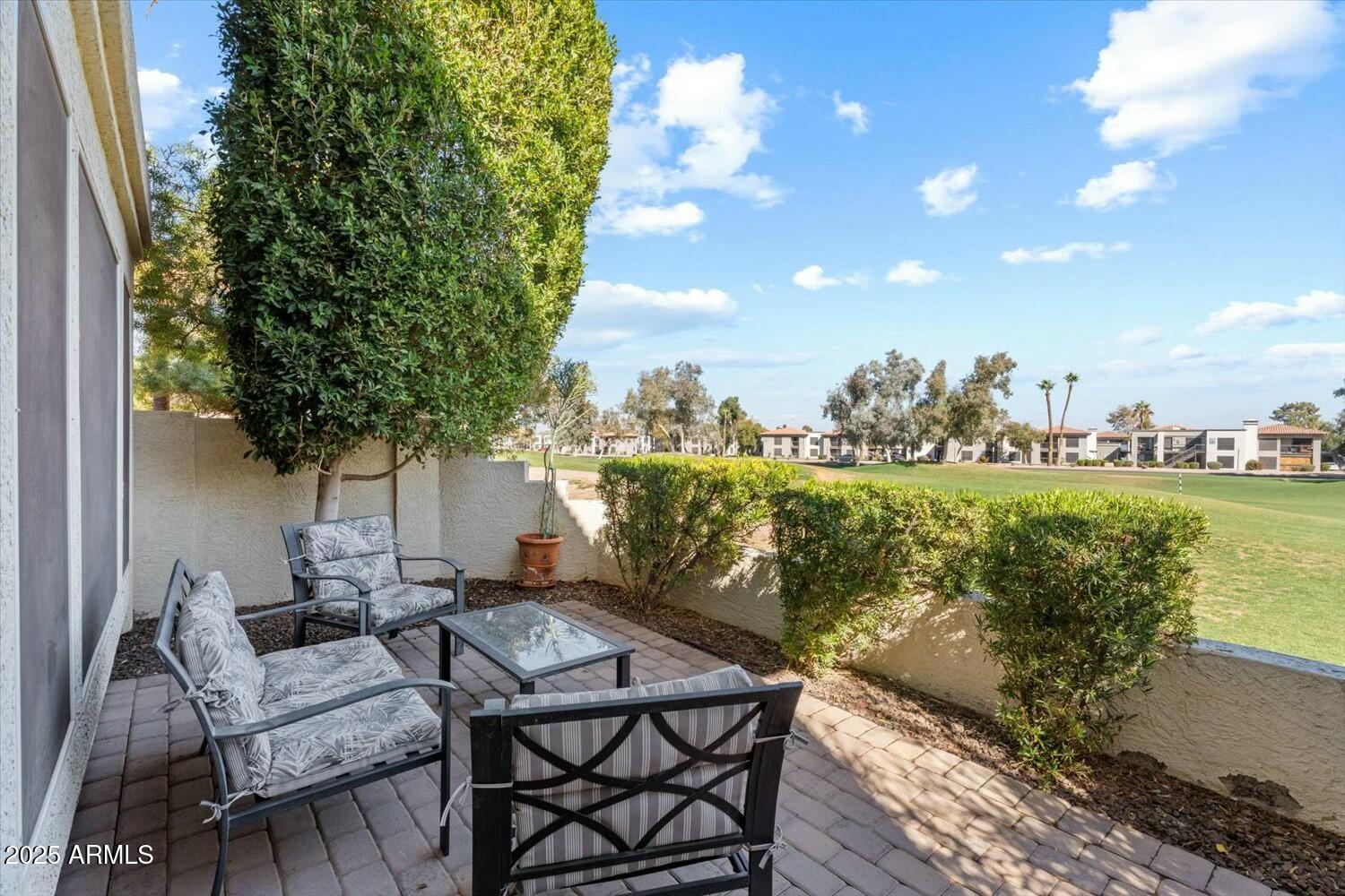 8813 South 51st Street, Unit 3 Phoenix, AZ 85044 - Photo 5 of 28 a view of a patio with table and chairs and potted plants