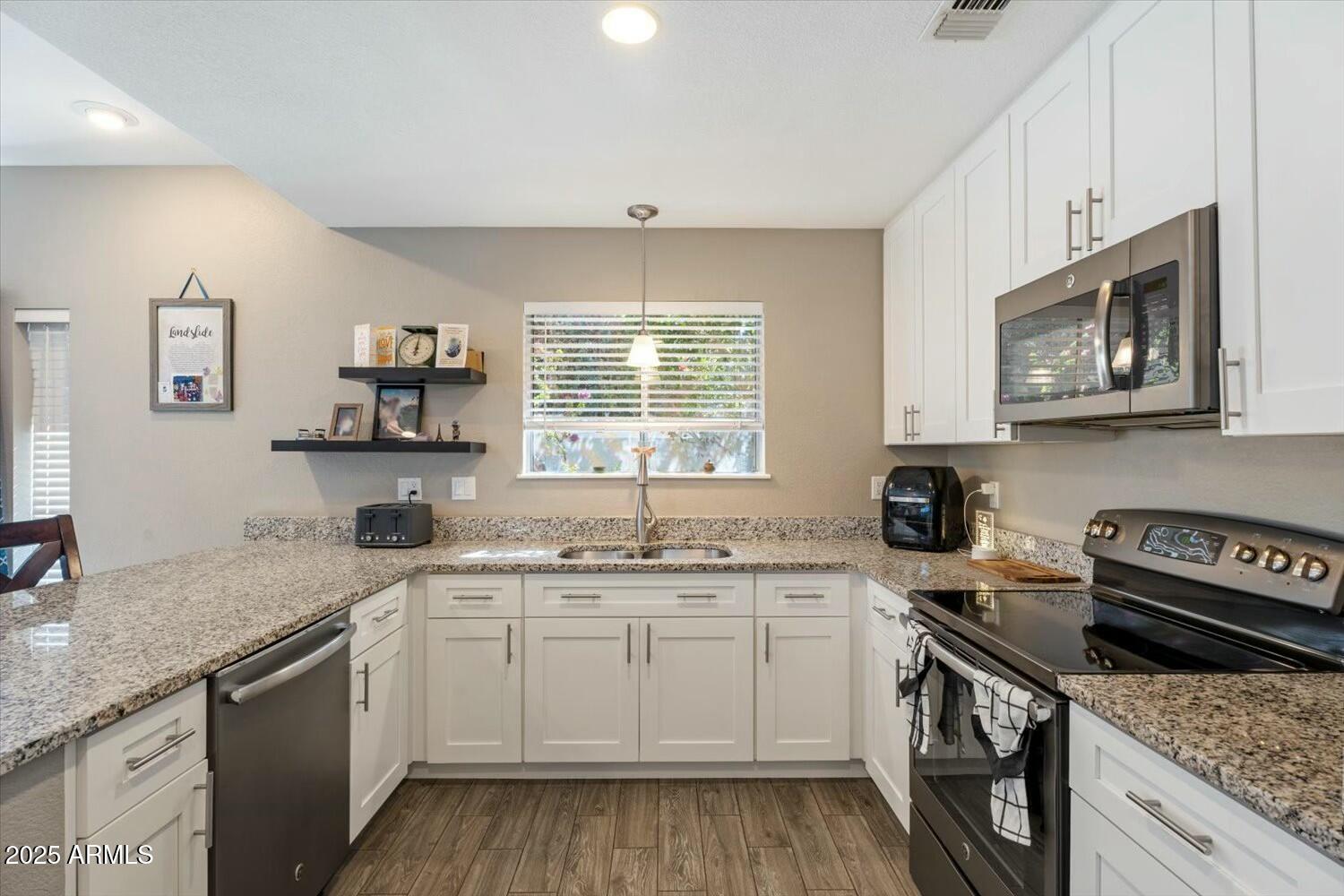 8813 South 51st Street, Unit 3 Phoenix, AZ 85044 - Photo 9 of 28 a kitchen with a sink stove and microwave