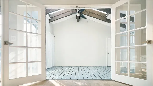 a view of a room with wooden floor and windows
