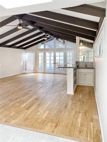a view of a kitchen with a stove and a wooden floor