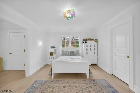 a spacious bedroom with a bed a couch and dresser