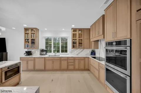 a kitchen with stove a sink and refrigerator