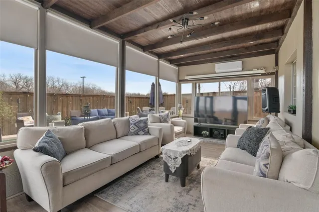 a living room with furniture and a floor to ceiling window