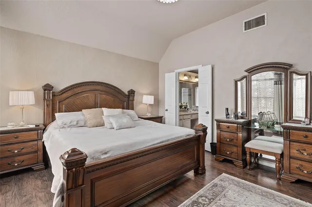 a bathroom with a bathtub a double vanity sink and mirror