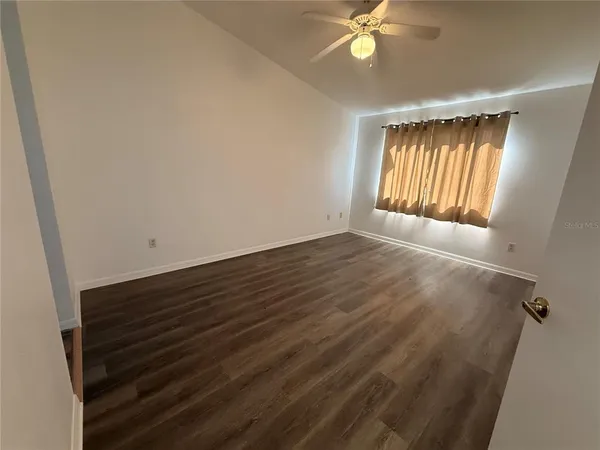 a view of wooden floor and windows in a room