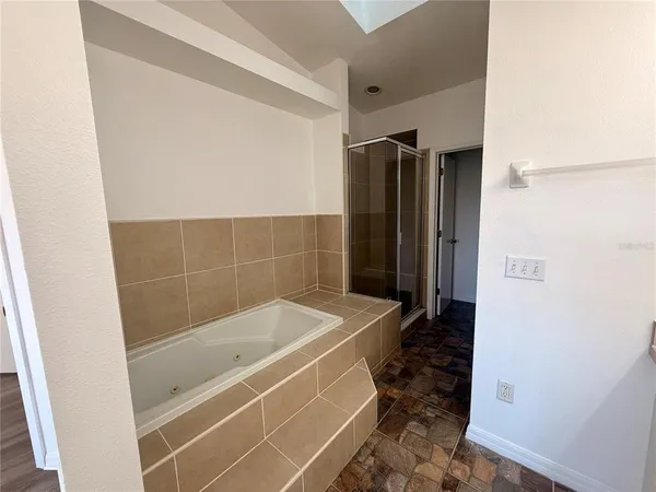 a front view of a house with swimming pool having outdoor seating