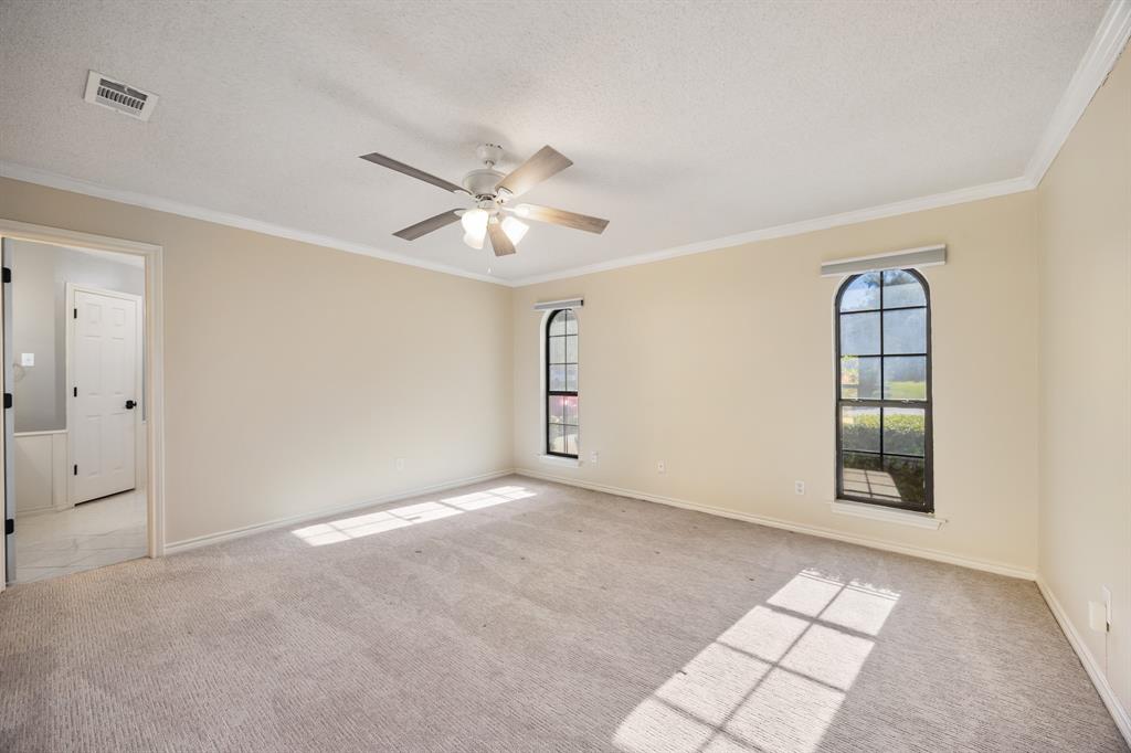 3002 Preston Court Rockwall, TX 75087 - Photo 16 of 39 an empty room with windows and ceiling fan