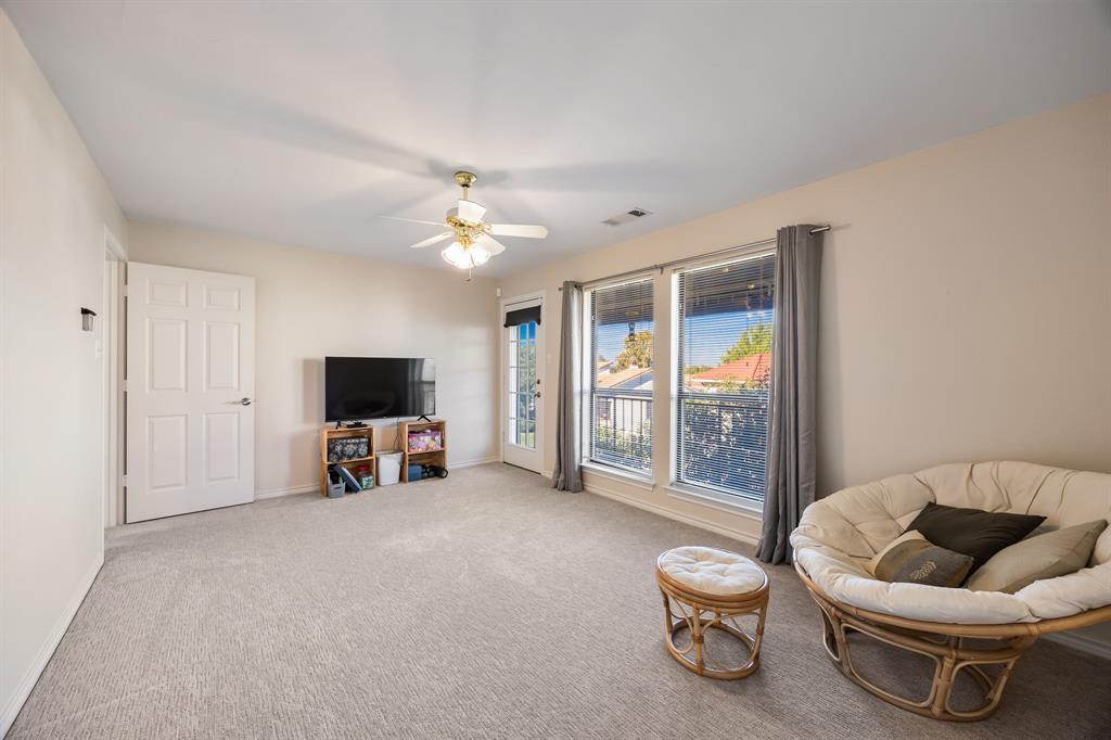 3002 Preston Court Rockwall, TX 75087 - Photo 22 of 39 a living room with furniture and a flat screen tv