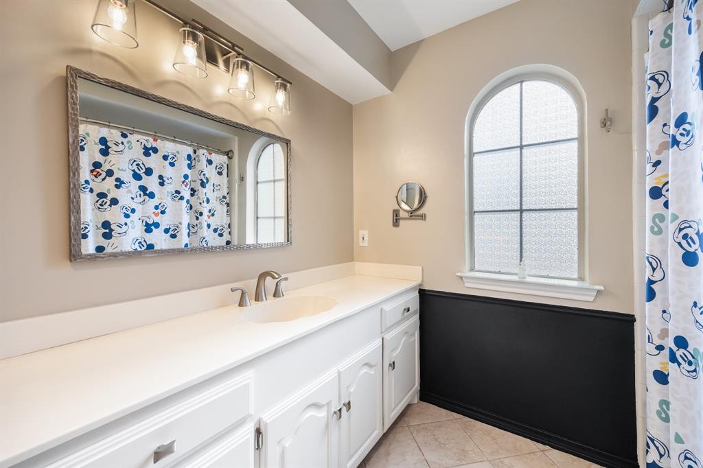 3002 Preston Court Rockwall, TX 75087 - Photo 23 of 39 a bathroom with a sink a mirror and a window