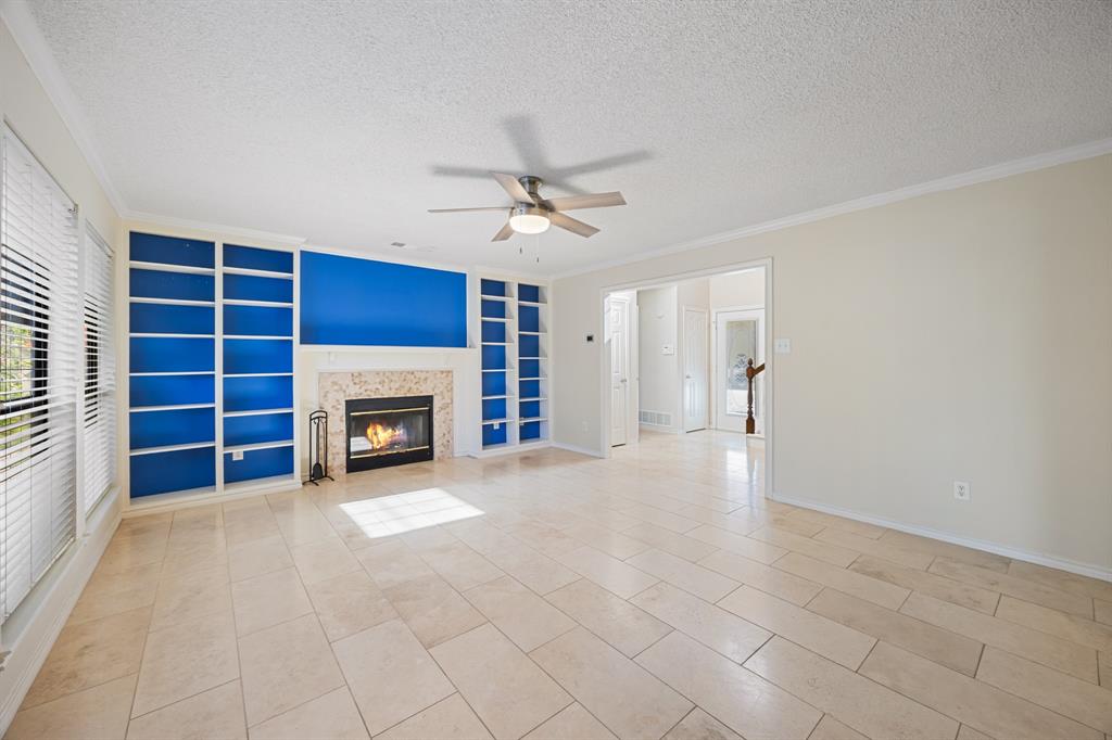 3002 Preston Court Rockwall, TX 75087 - Photo 6 of 39 an empty room with windows and a fireplace