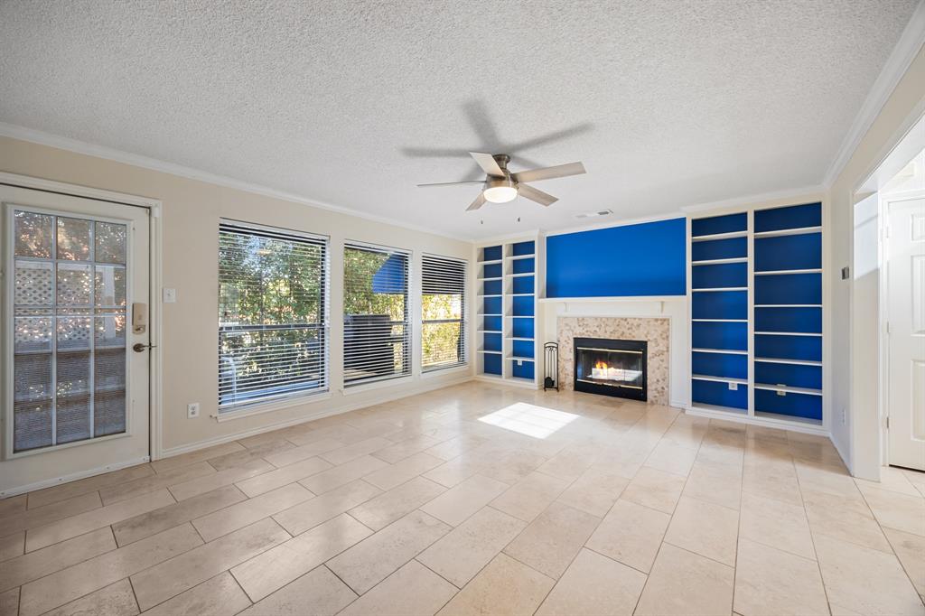 3002 Preston Court Rockwall, TX 75087 - Photo 7 of 39 a view of an empty room with a fireplace and a window
