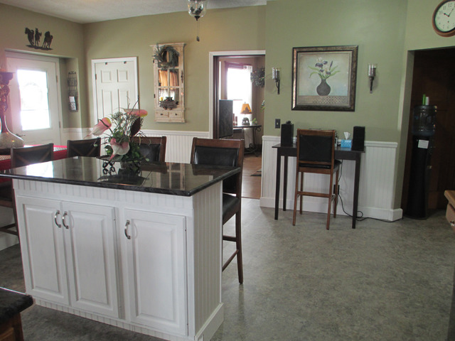 3534 East 1st Road Peru, IL 61354 - Photo 9 of 21 a kitchen with stainless steel appliances a sink a table and chairs
