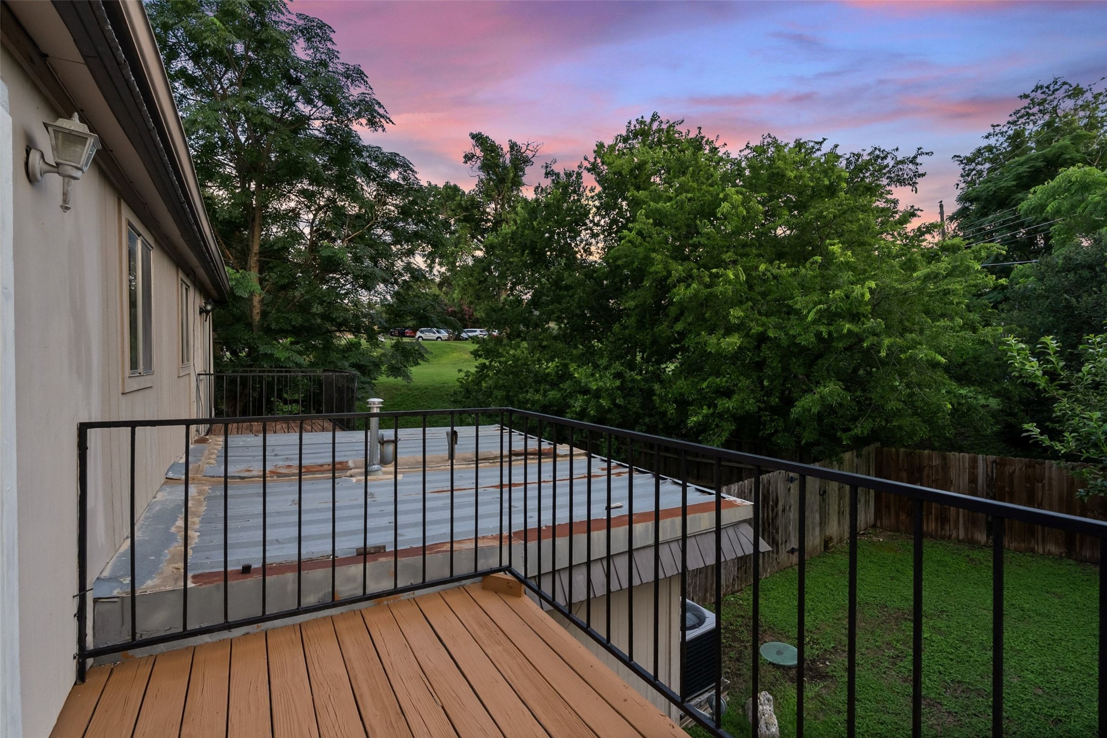 702 Castle Ridge Road, Unit C Austin, TX 78746 - Photo 13 of 36 Upstairs, two spacious bedrooms provide comfortable accommodations. One bedroom includes a walk-in closet, while the second features access to a private balcony.
