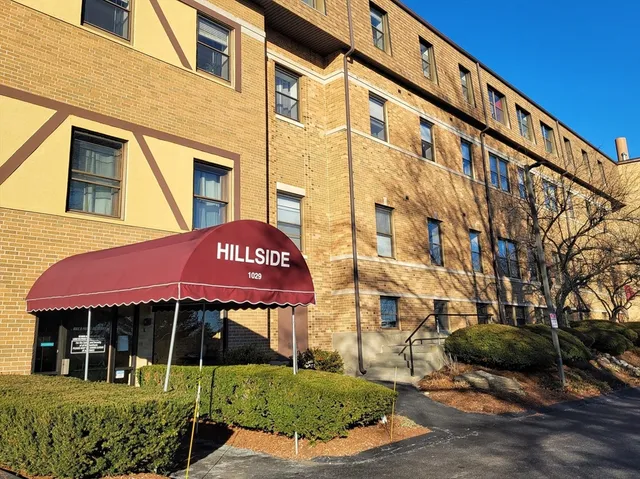 a front view of a building with a garden