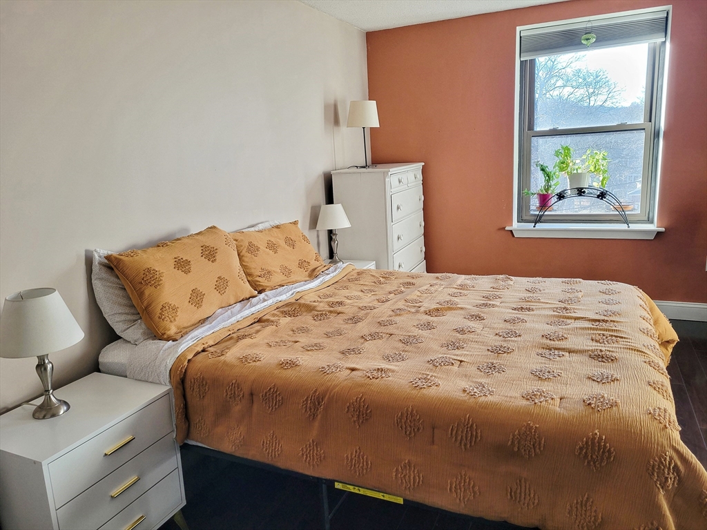 1029 Pleasant Street, Unit 20 Worcester, MA 01602 - Photo 11 of 16 a bedroom with a bed and a window