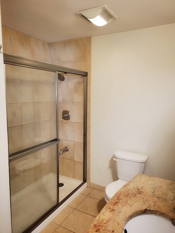 1029 Pleasant Street, Unit 20 Worcester, MA 01602 - Photo 8 of 16 a bathroom with a toilet and a shower