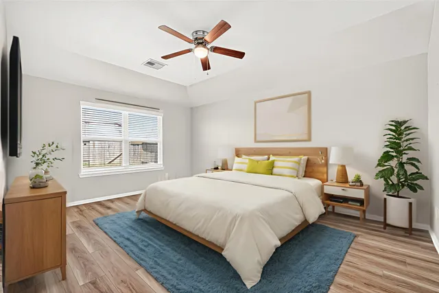 a bedroom with a large bed and a chandelier