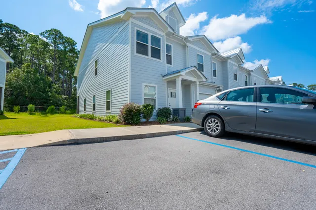 a view of a car parked in front of a house