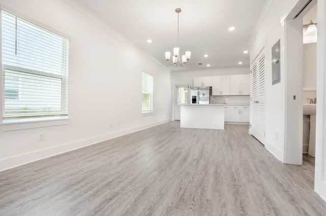 a big room with wooden floor and windows