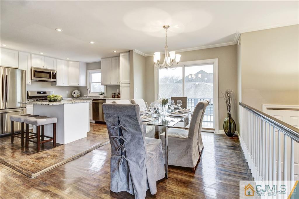 40 Foley Avenue Edison, NJ 08820 - Photo 5 of 19 a dining room with stainless steel appliances kitchen island granite countertop a dining table chairs and view living room