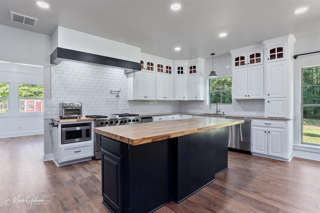 550 Linton Bellevue Road Benton, LA 71006 - Photo 14 of 37 Kitchen with butcher block countertops, recessed lighting, durable wood laminate flooring, and white cabinetry