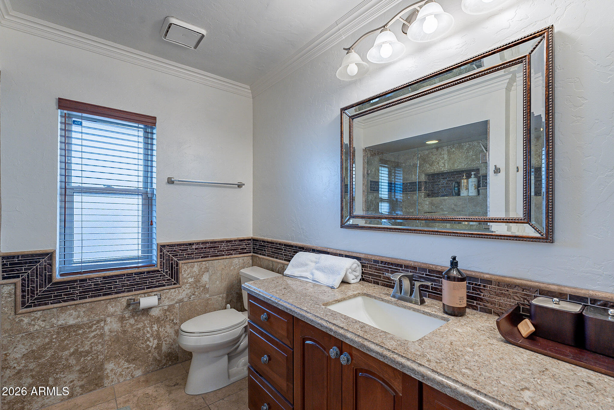 4226 East North Lane Phoenix, AZ 85028 - Photo 33 of 43 a bathroom with a granite countertop sink a toilet and mirror