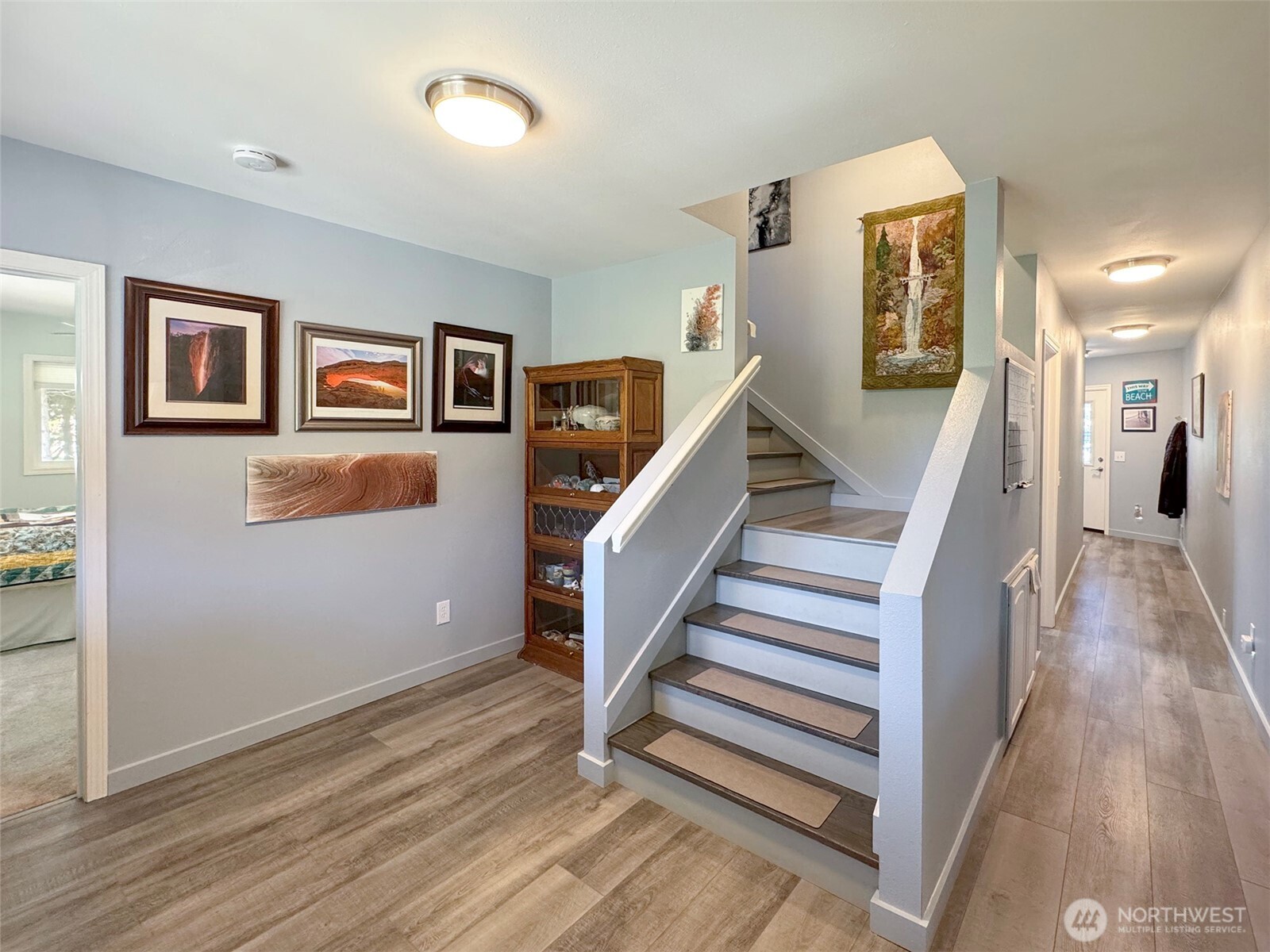 866 Jamestown Road Sequim, WA 98382 - Photo 19 of 40 a view of a hallway with wooden floor and stairs