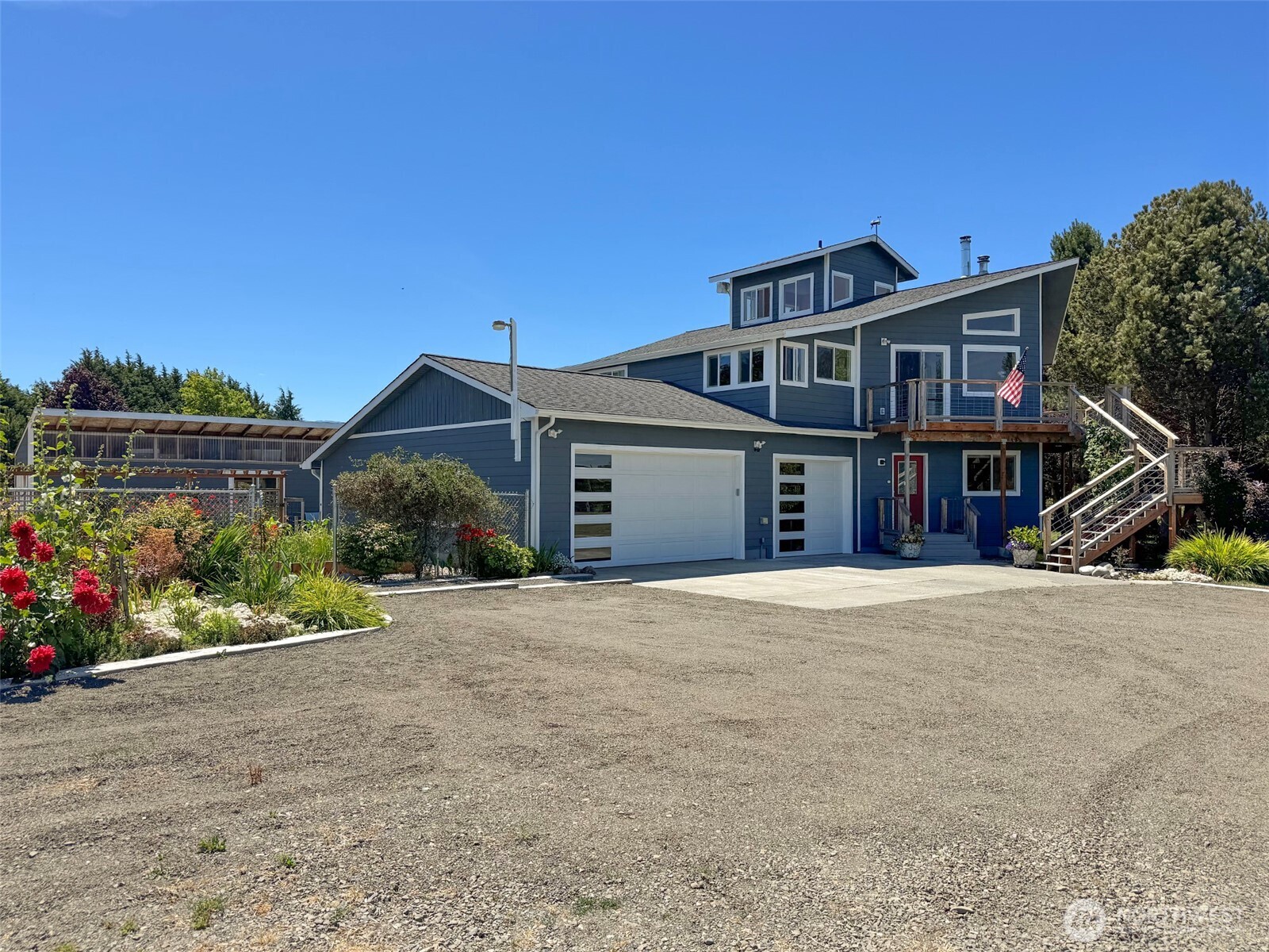 866 Jamestown Road Sequim, WA 98382 - Photo 2 of 40 a front view of a house with a garden