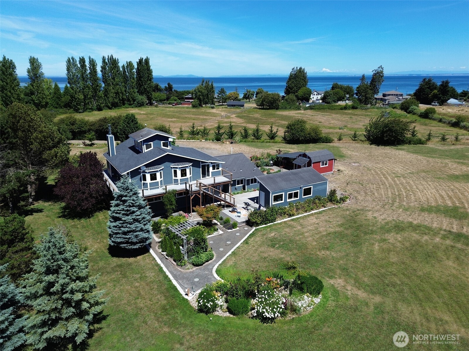 866 Jamestown Road Sequim, WA 98382 - Photo 6 of 40 an aerial view of a house with garden space and lake view