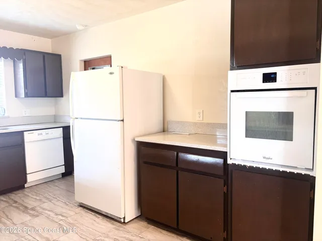 a kitchen with a refrigerator and a stove