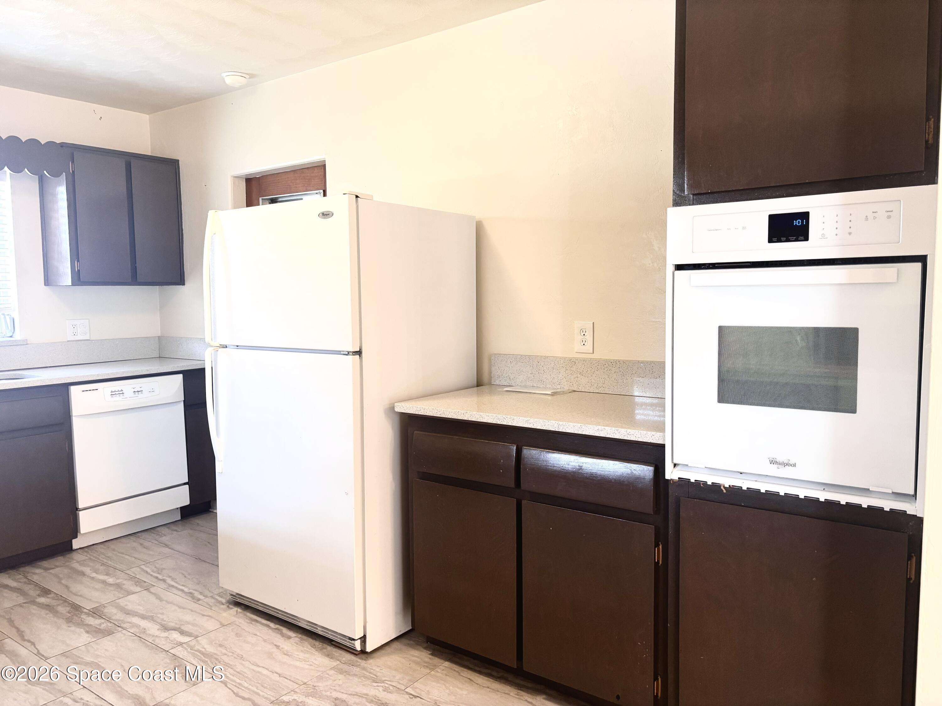 19 Orange Avenue Rockledge, FL 32955 - Photo 11 of 25 a kitchen with a refrigerator and a stove