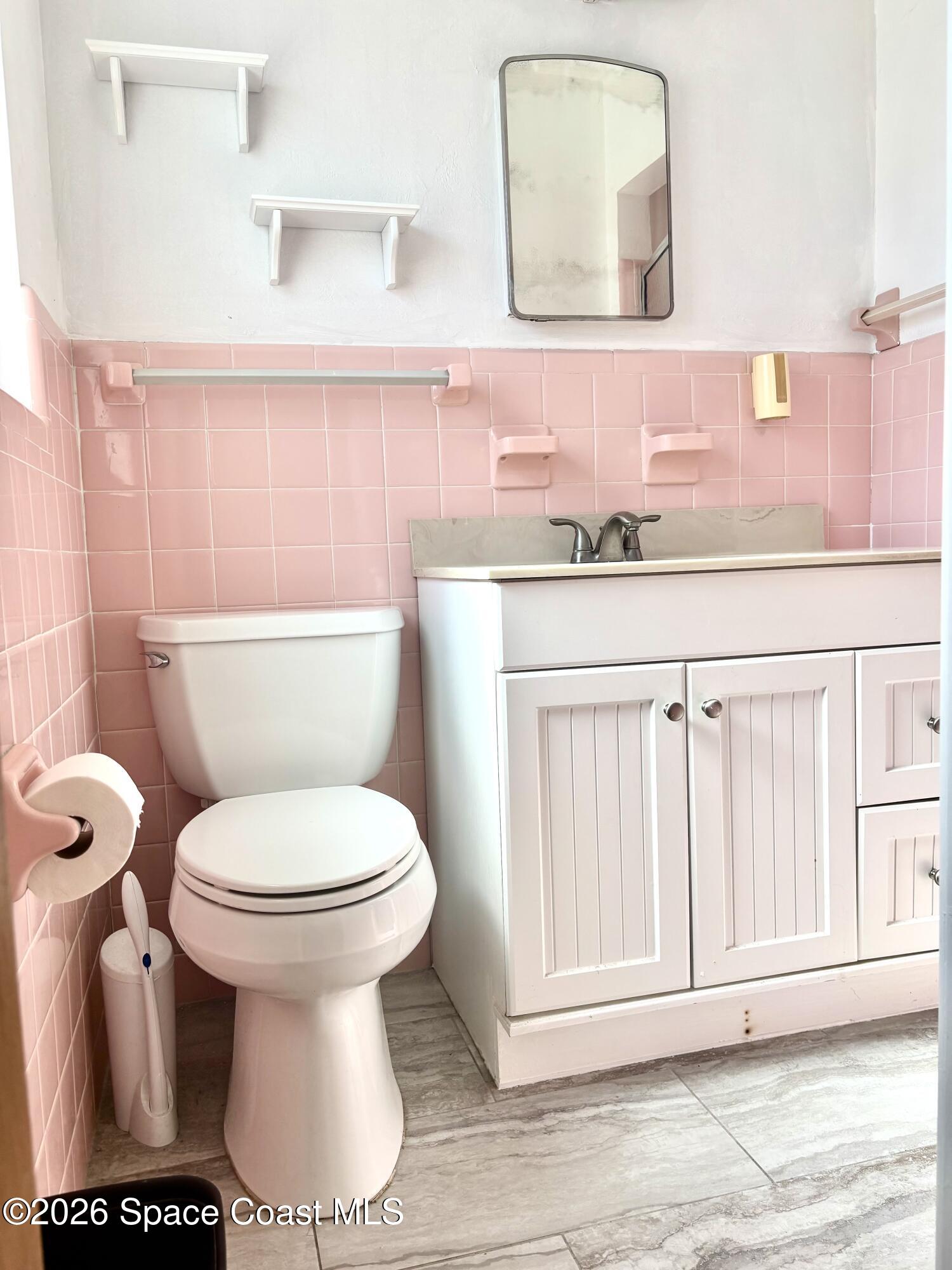 19 Orange Avenue Rockledge, FL 32955 - Photo 17 of 25 a bathroom with a toilet sink and mirror