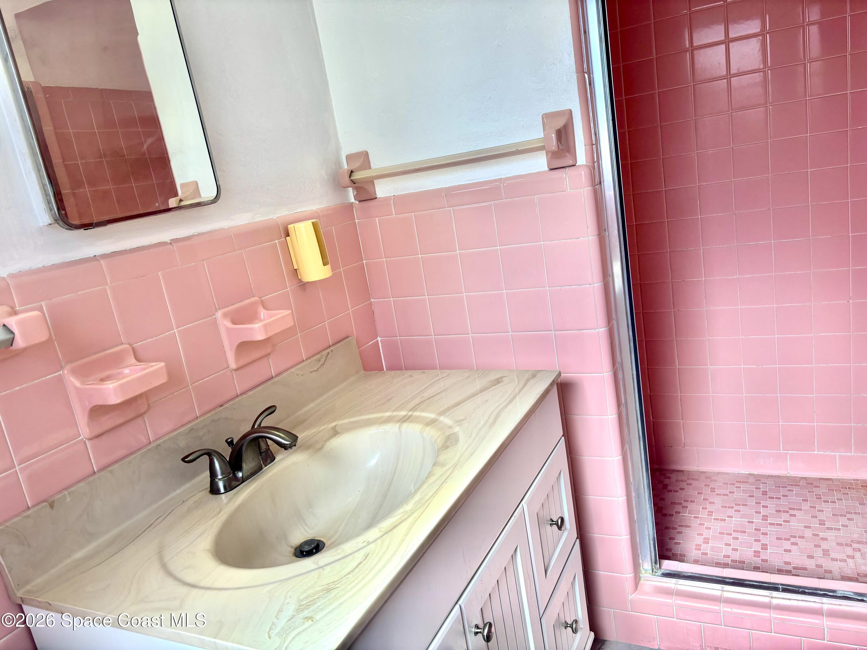 19 Orange Avenue Rockledge, FL 32955 - Photo 18 of 25 a bathroom with a sink and a mirror