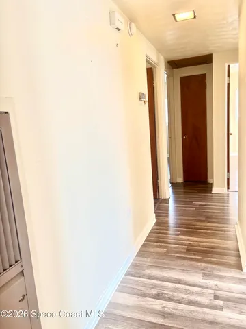 a view of a room with wooden floor