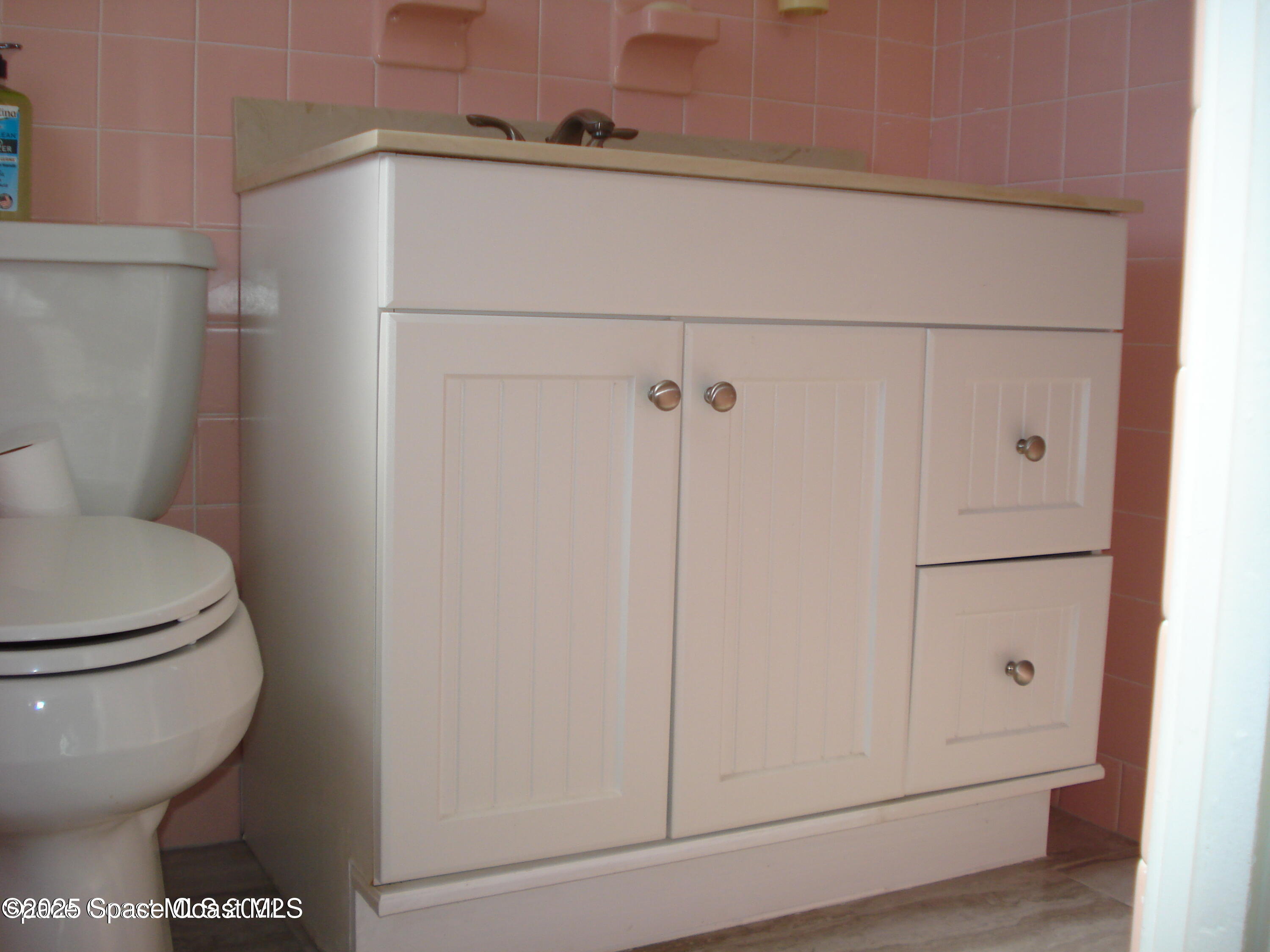 19 Orange Avenue Rockledge, FL 32955 - Photo 23 of 25 a toilet sitting next to a white cabinet