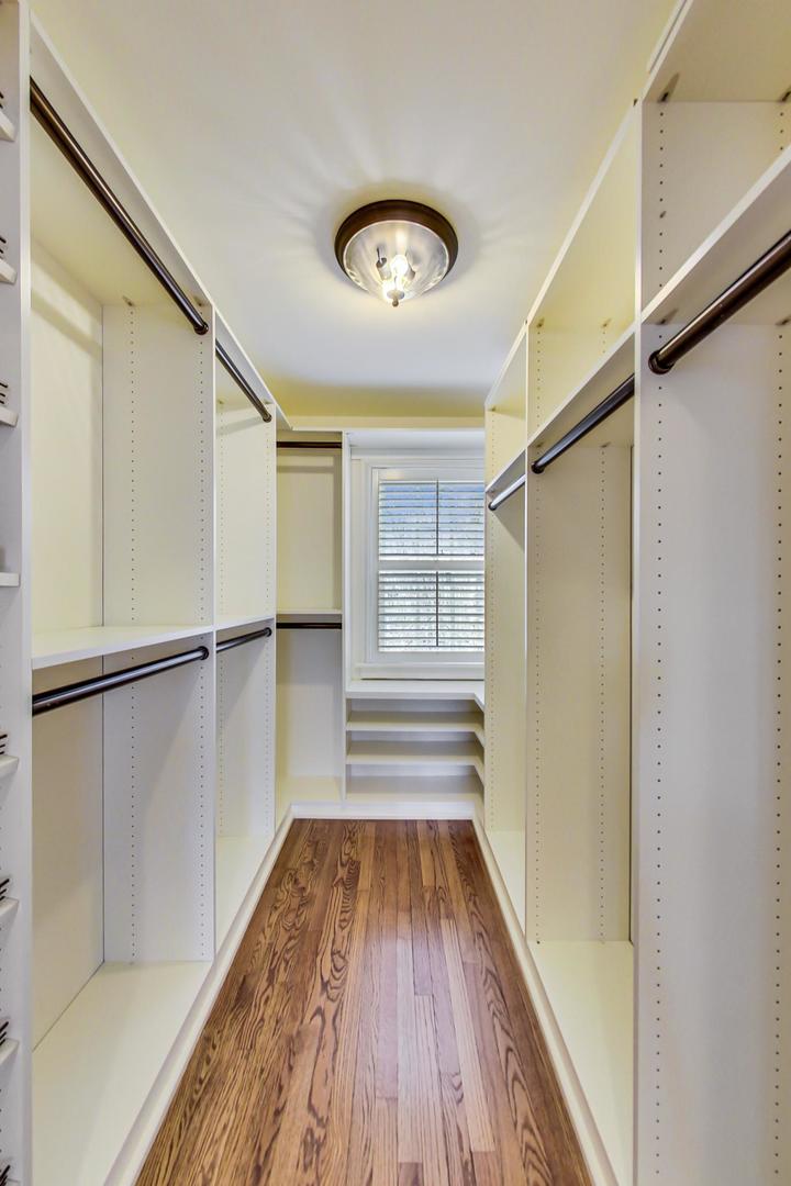 150 Firth Road Inverness, IL 60067 - Photo 43 of 83 a view of walk in closet with wooden floor and fan