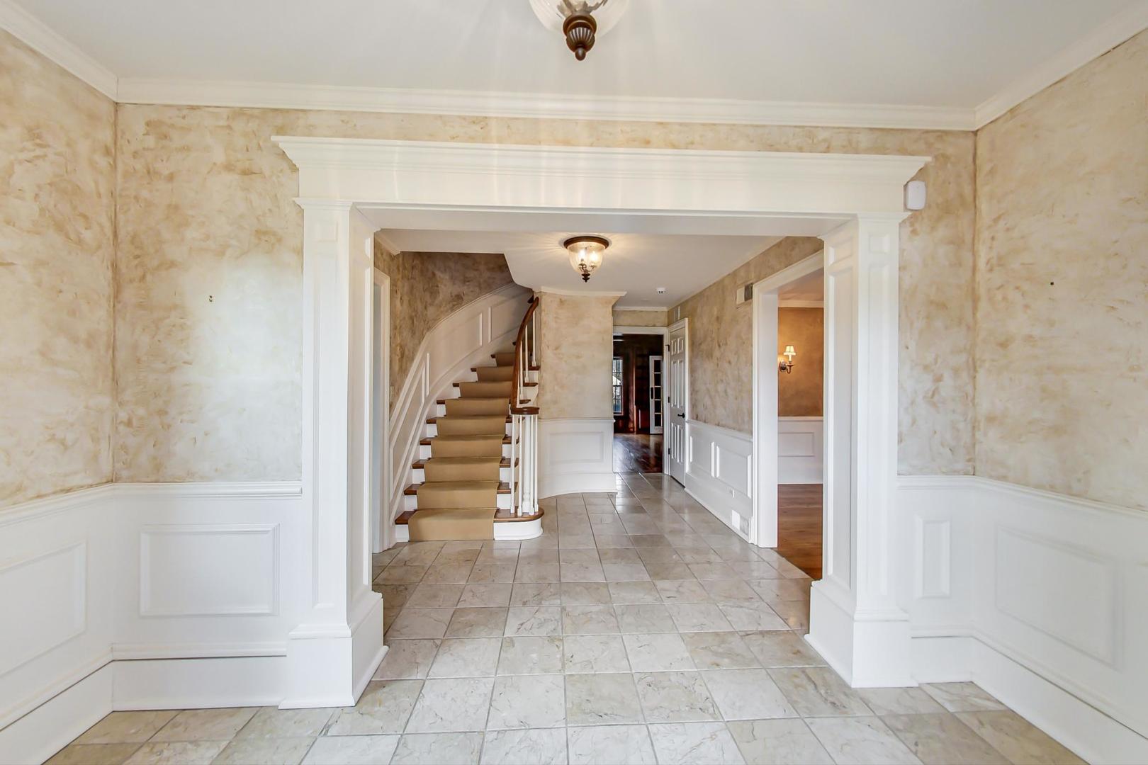 150 Firth Road Inverness, IL 60067 - Photo 9 of 83 a view of a hallway with wooden floor and entryway