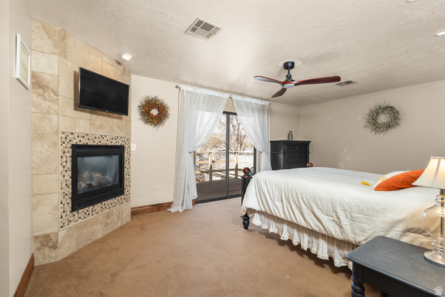 892 Cambridge Drive St. George, UT 84770 - Photo 46 of 65 Carpeted room featuring a tiled fireplace with mosaic accents, recessed lighting, and a ceiling fan