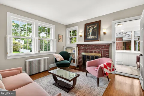 a living room with furniture a fireplace and a large window