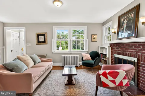 a living room with furniture fireplace and window