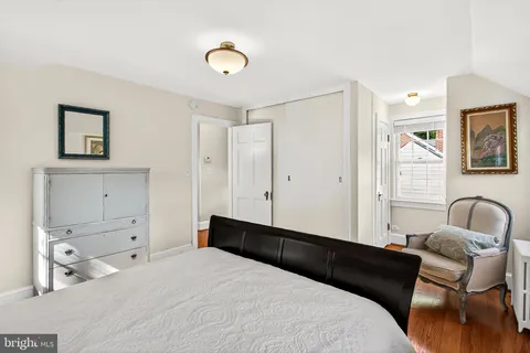 a bedroom with a bed and a chair