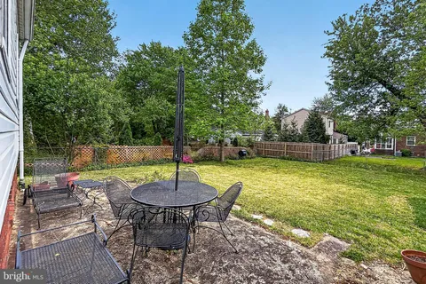 a backyard of a house with barbeque oven