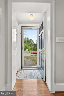 a view of hallway with wooden floor and window